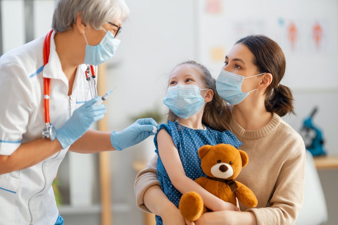 A woman and child wearing protective mask and gloves.